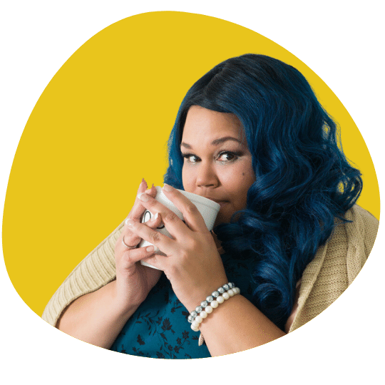 Fat black woman with blue hair staring at the camera and drinking from a white mug
